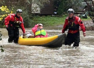 Crews brave Snoqualmie River flooding to rescue three people and dog from home