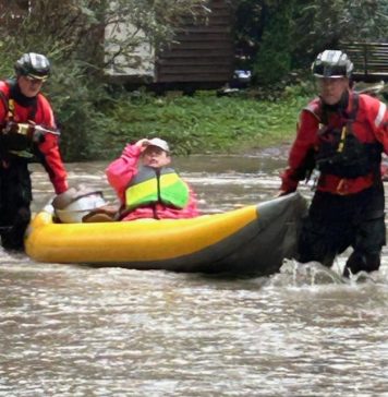 Crews brave Snoqualmie River flooding to rescue three people and dog from home